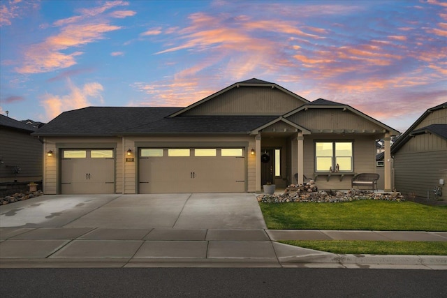 view of front of home with a garage and a yard