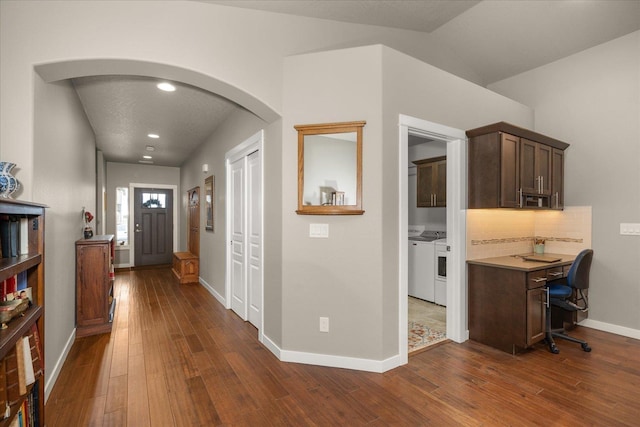 hallway featuring vaulted ceiling and dark hardwood / wood-style flooring