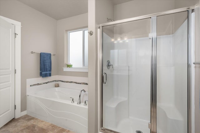 bathroom featuring a textured ceiling and separate shower and tub