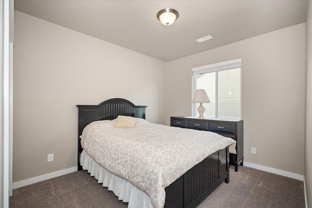 bedroom with dark colored carpet