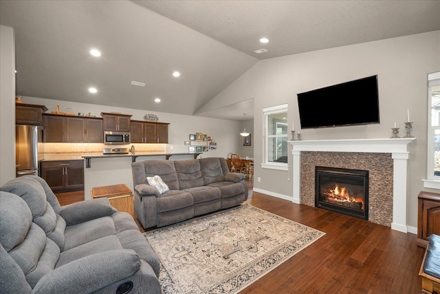 living room with dark wood-type flooring and vaulted ceiling