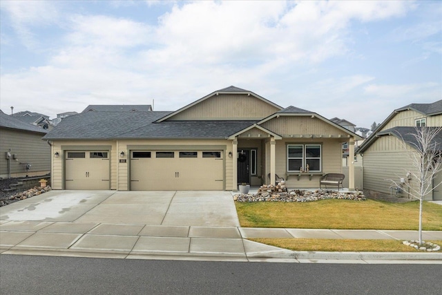 view of front of home featuring a front yard and a garage