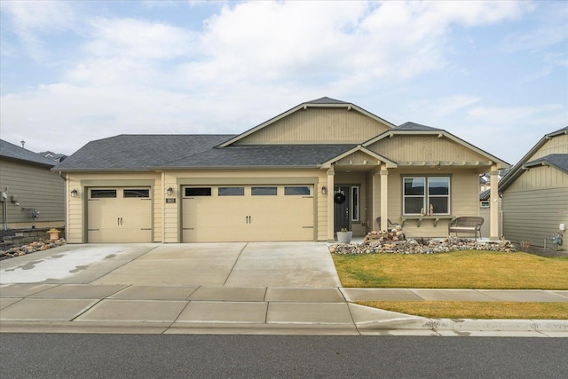 view of front of home featuring a front yard and a garage