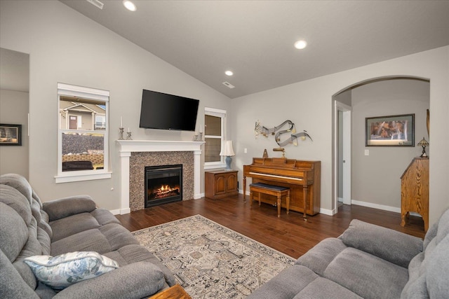 living room featuring high vaulted ceiling and dark hardwood / wood-style flooring