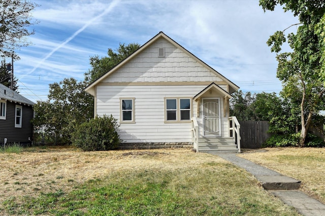 bungalow-style home featuring a front lawn