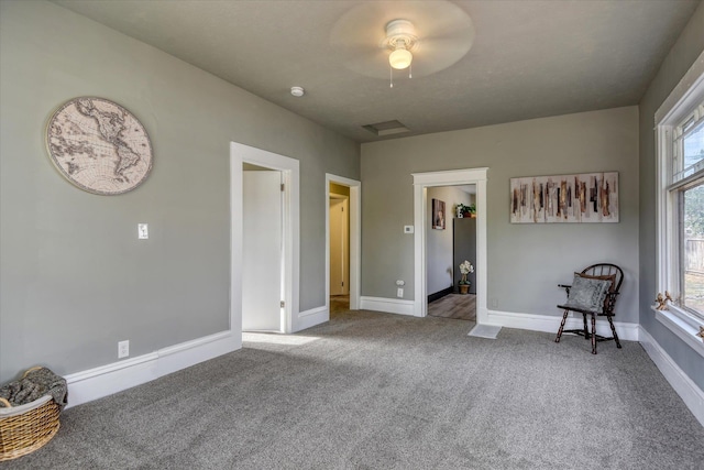 unfurnished bedroom with ceiling fan and carpet