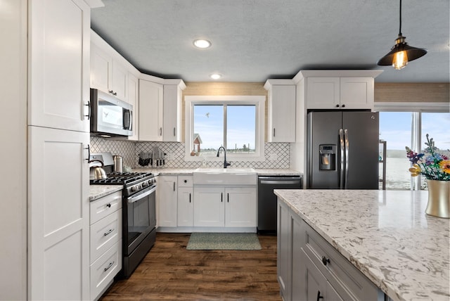 kitchen featuring stainless steel appliances, white cabinets, and sink