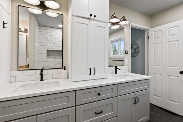 bathroom featuring vanity and backsplash