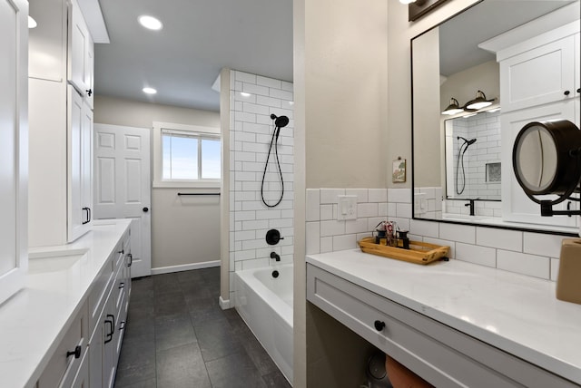 bathroom featuring tile patterned flooring, decorative backsplash, vanity, and tiled shower / bath