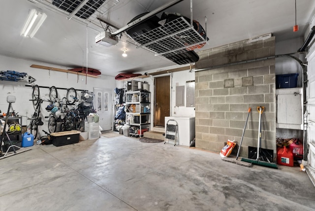 garage with a garage door opener and washer / clothes dryer