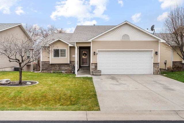 view of front of property featuring a front lawn and a garage