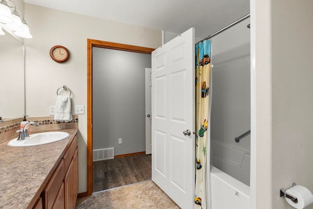 bathroom with vanity and shower / tub combo with curtain