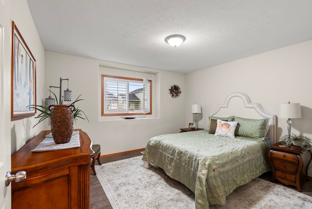 bedroom with hardwood / wood-style flooring and a textured ceiling