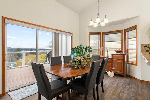 dining space featuring lofted ceiling, a chandelier, and dark wood-type flooring