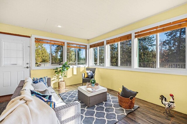 living room with lofted ceiling, hardwood / wood-style floors, a fireplace, and ceiling fan