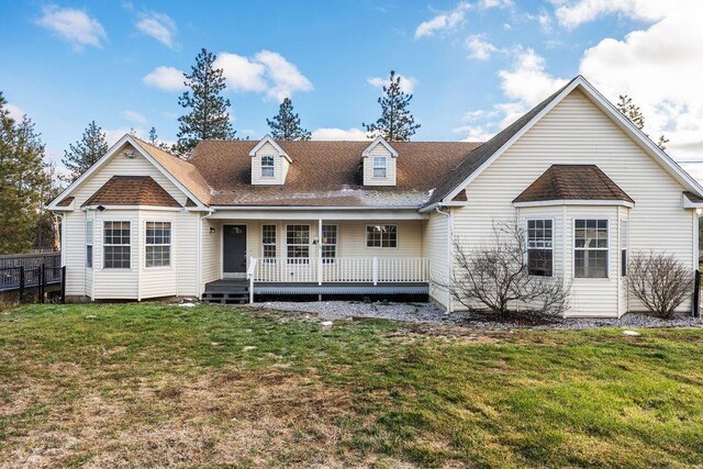 rear view of house with a deck and a yard