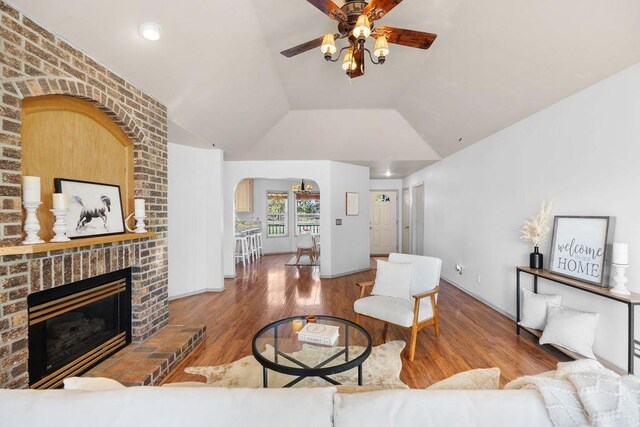 living room featuring wood-type flooring and a fireplace