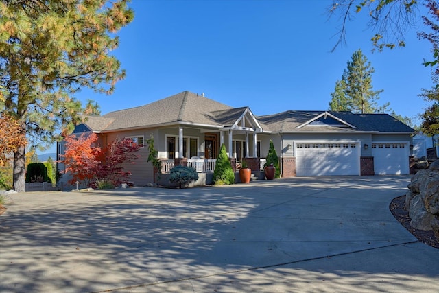 view of front of house with covered porch and a garage