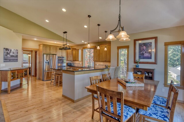 dining space featuring an inviting chandelier, a wealth of natural light, and a mountain view