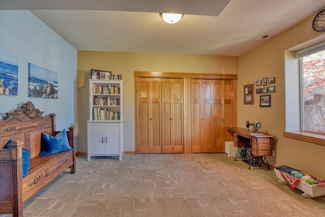 living room with a fireplace, a chandelier, and light carpet