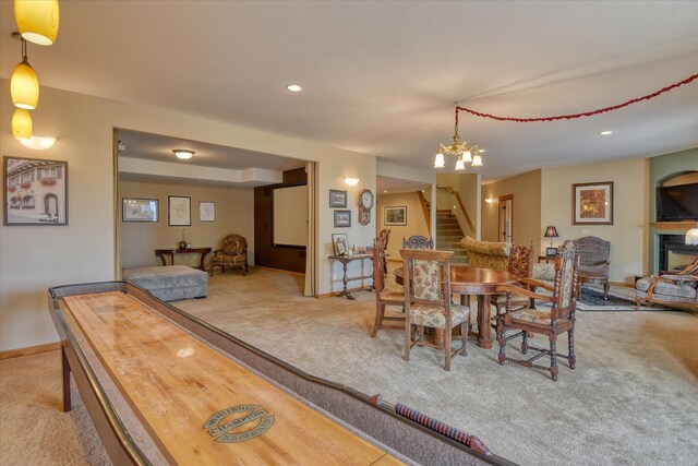 dining room with an inviting chandelier and light colored carpet