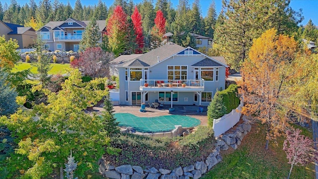 back of house with a patio area and a balcony