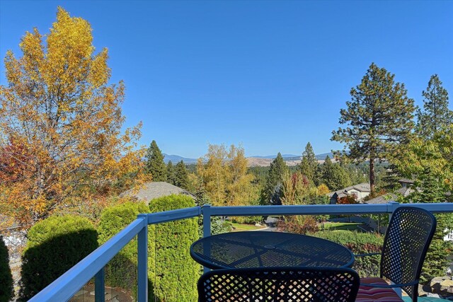 back of property with a balcony, a patio, and a covered pool