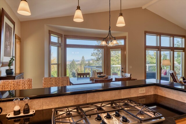 dining space with sink, vaulted ceiling, and light hardwood / wood-style flooring