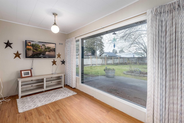 interior space with hardwood / wood-style floors and crown molding