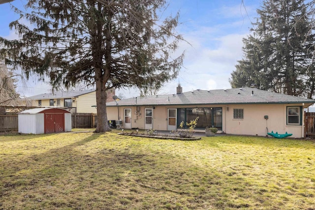 back of property with a lawn, a storage shed, and a patio