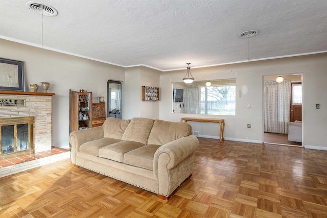 living room featuring a fireplace, a textured ceiling, and parquet floors