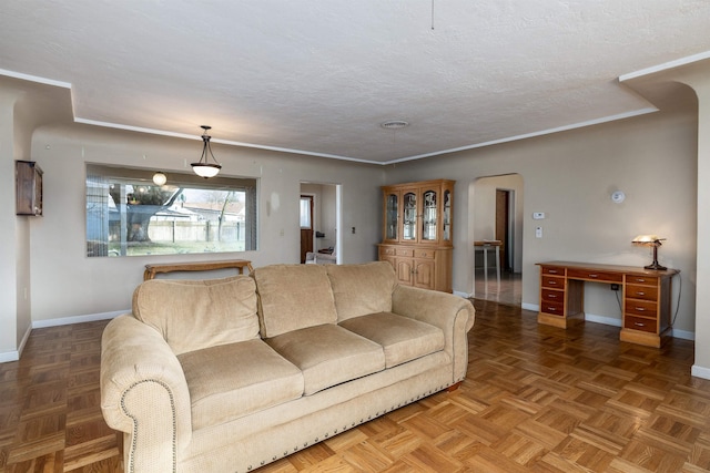 living room featuring dark parquet flooring and a textured ceiling