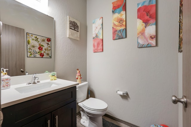 bathroom with toilet and vanity