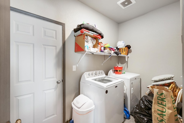 clothes washing area featuring separate washer and dryer