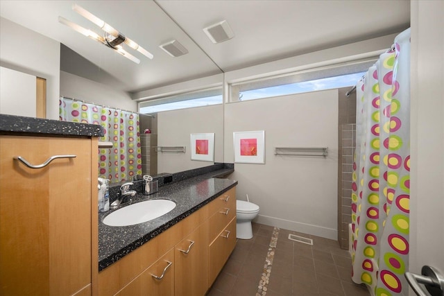 bathroom featuring toilet, tile patterned floors, and vanity