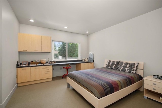 bedroom featuring built in desk and carpet flooring