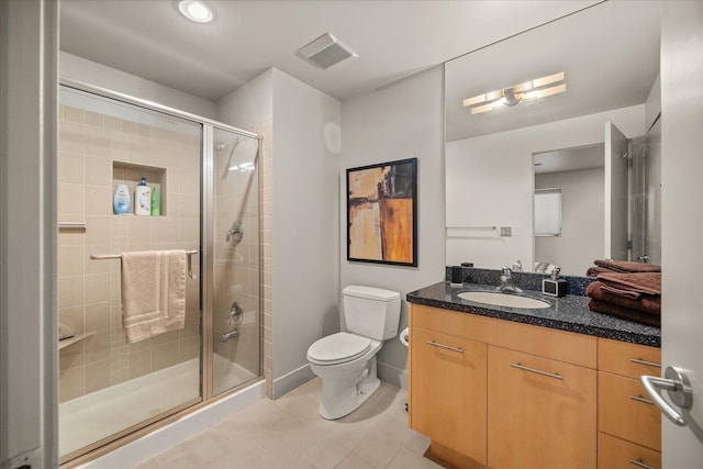 bathroom with toilet, a shower with door, and vanity