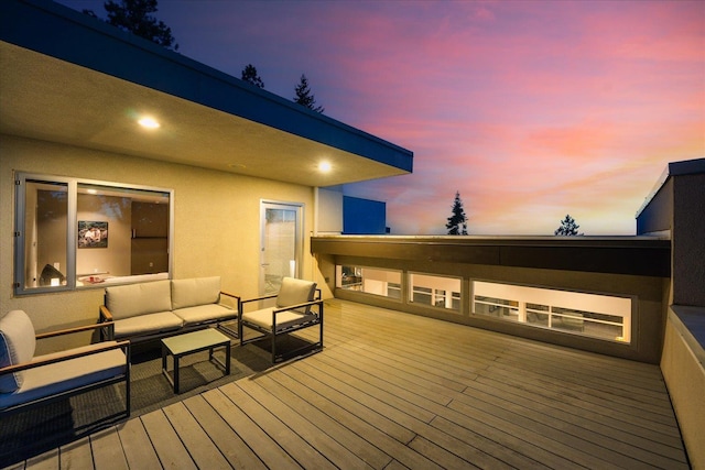 deck at dusk featuring outdoor lounge area