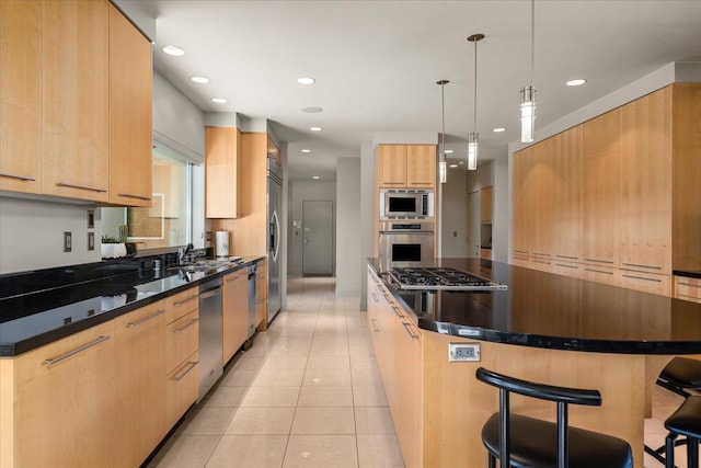 kitchen with hanging light fixtures, stainless steel appliances, a center island, light tile patterned floors, and a kitchen bar