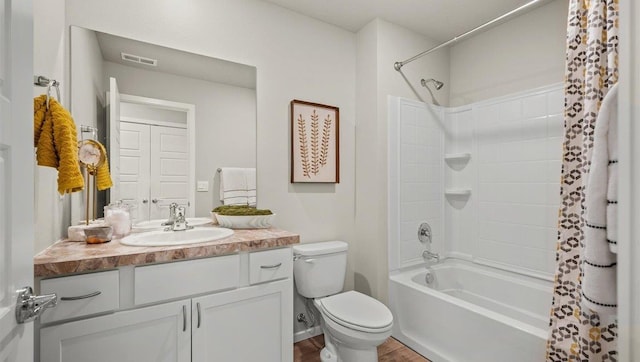 full bathroom with wood-type flooring, shower / tub combo with curtain, vanity, and toilet