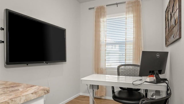 office space with a wealth of natural light and wood-type flooring