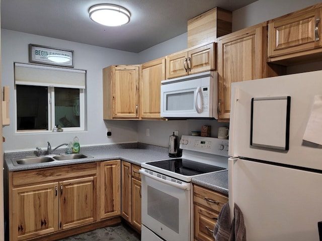 kitchen featuring white appliances and sink