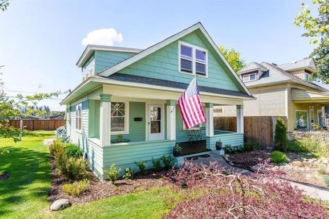 view of front of house featuring a front yard and covered porch