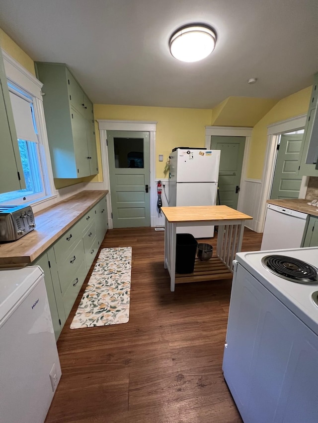 kitchen featuring white appliances, dark hardwood / wood-style floors, and green cabinets