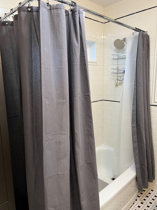 bathroom with shower / tub combo and tile patterned floors