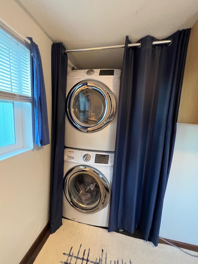 laundry area featuring stacked washer and clothes dryer