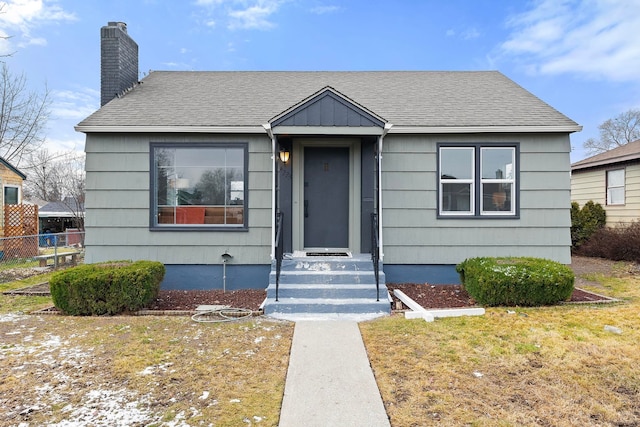 bungalow-style home featuring a front yard