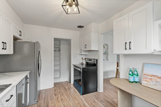 kitchen featuring white cabinetry, light hardwood / wood-style floors, light stone counters, and appliances with stainless steel finishes