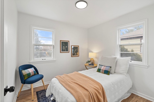 bedroom featuring wood-type flooring and multiple windows