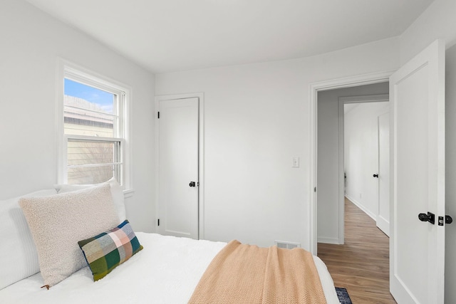 bedroom with hardwood / wood-style floors